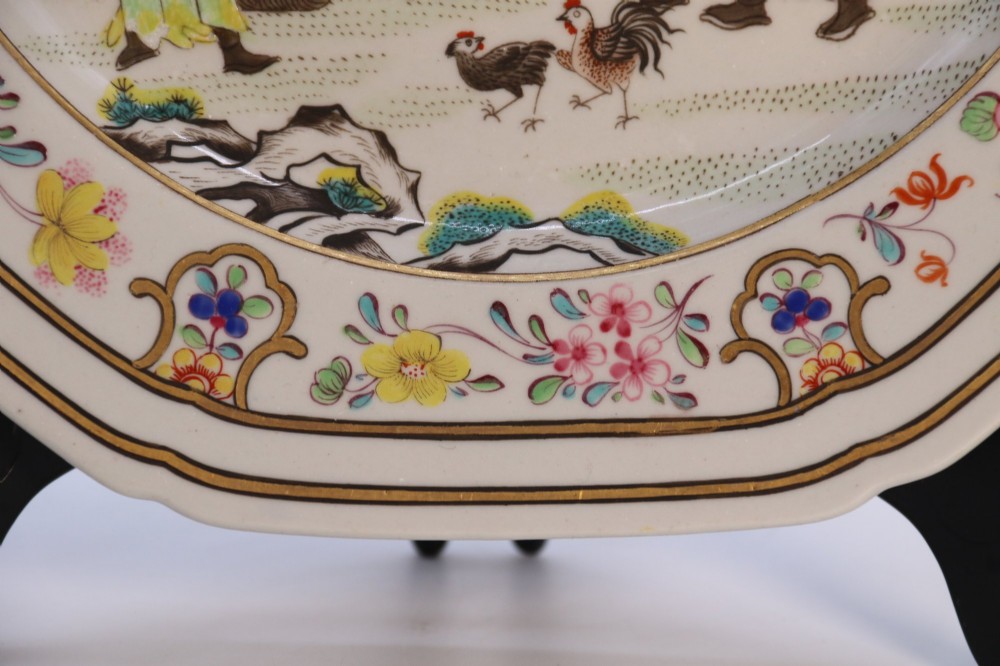 A pair of early nineteenth-century octagonal Spode stone china cabinet plates decorated with polychrome Chinoiserie garden scenes and floral borders. View IX