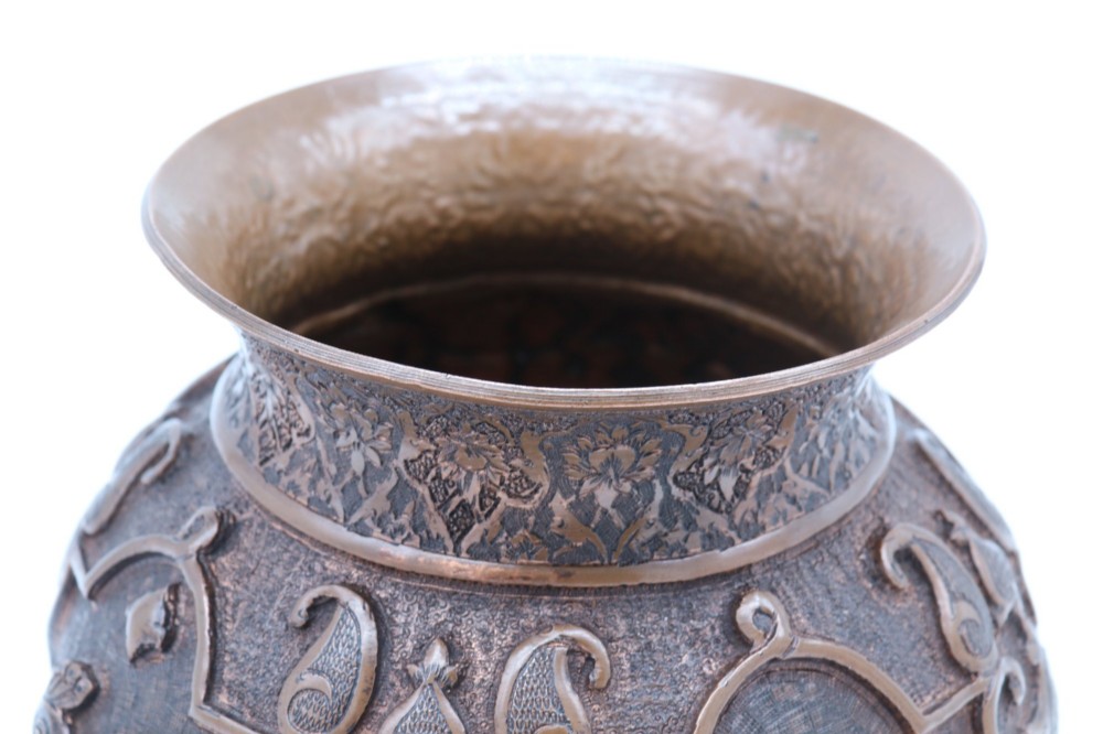 A bulbous late nineteenth-century copper vase featuring detailed repousse carvings of a mounted archer within a central cartouche surrounded by scrollwork and a fluted base. View XIII