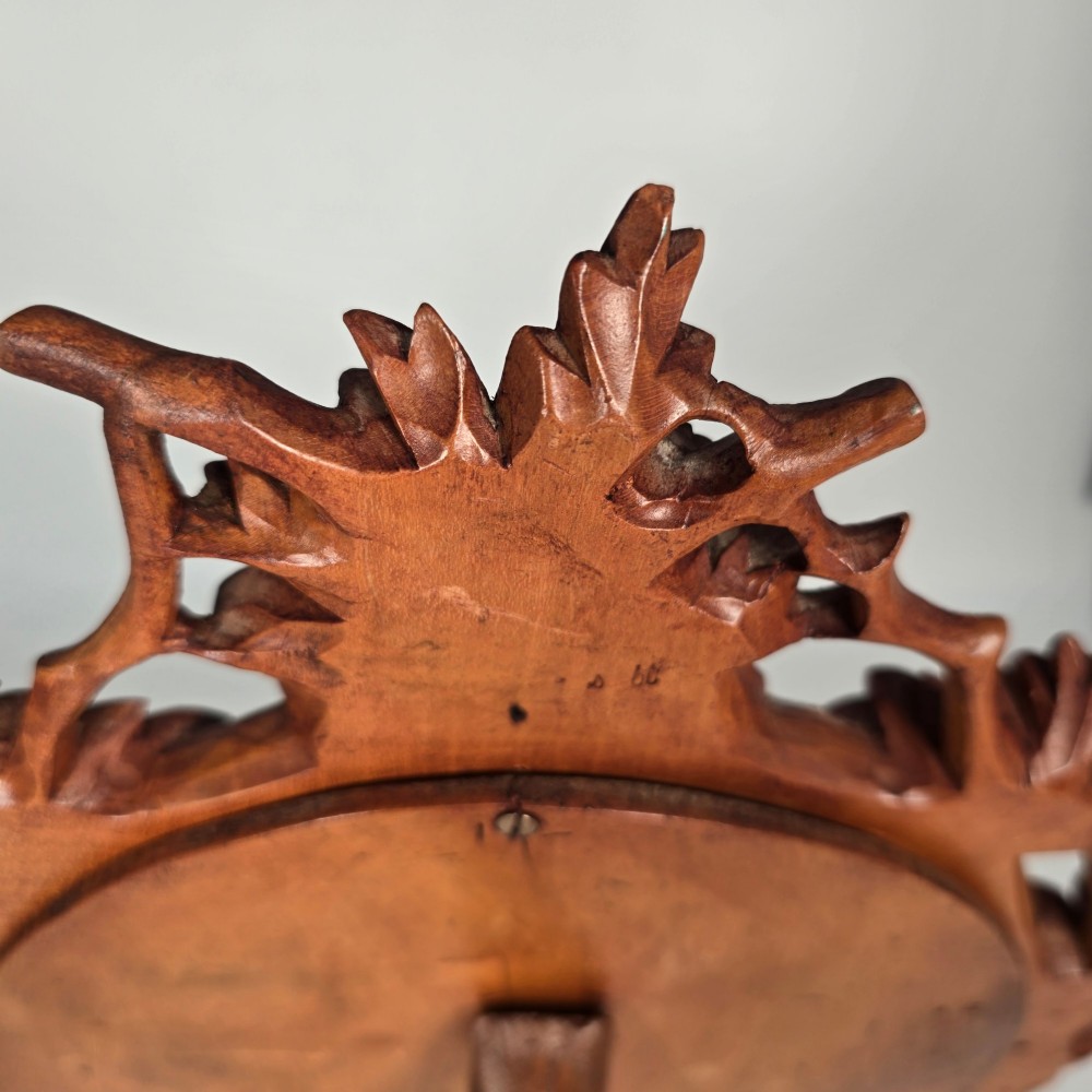 A late nineteenth-century Swiss carved lime wood oval table mirror surrounded by relief carvings of grapevine leaves and grapes. View VIII