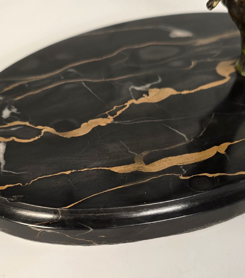A cold-painted bronze sculpture featuring three blue and grey budgerigars perched on a leafy bronze branch, mounted on an oval dark marble base. View VII
