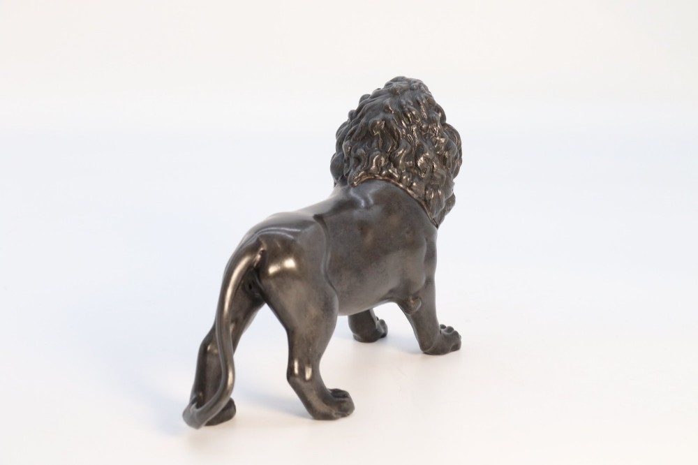 A dark patinated pewter sculpture depicting a standing male lion with a flowing mane and open mouth. View VII