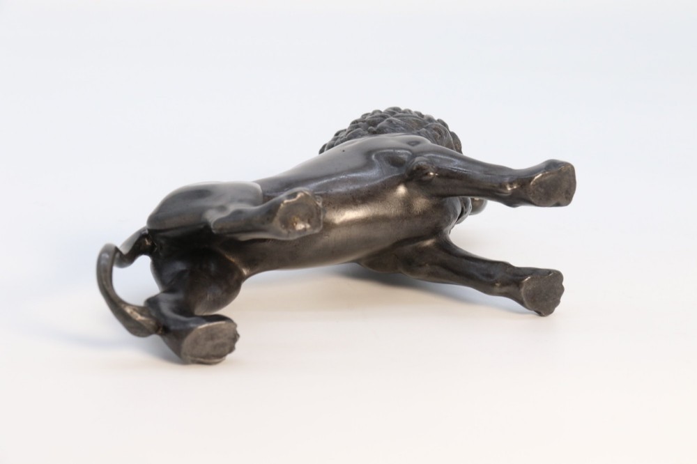 A dark patinated pewter sculpture depicting a standing male lion with a flowing mane and open mouth. View IX