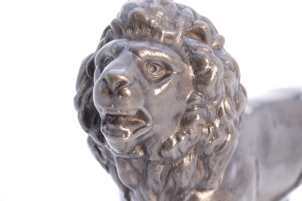 A dark patinated pewter sculpture depicting a standing male lion with a flowing mane and open mouth. View XI