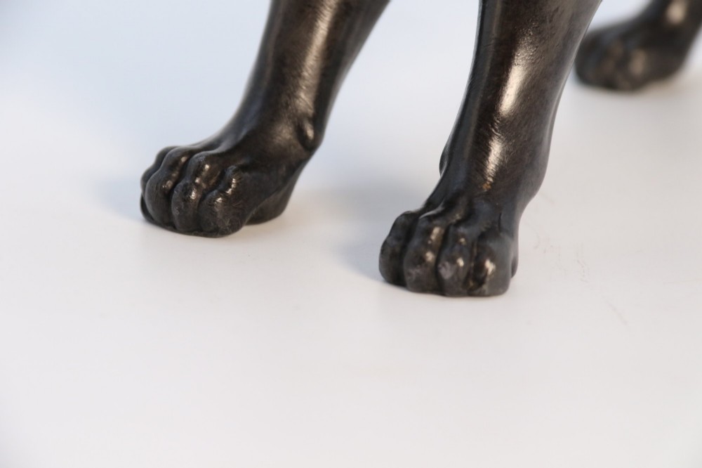A dark patinated pewter sculpture depicting a standing male lion with a flowing mane and open mouth. View XII