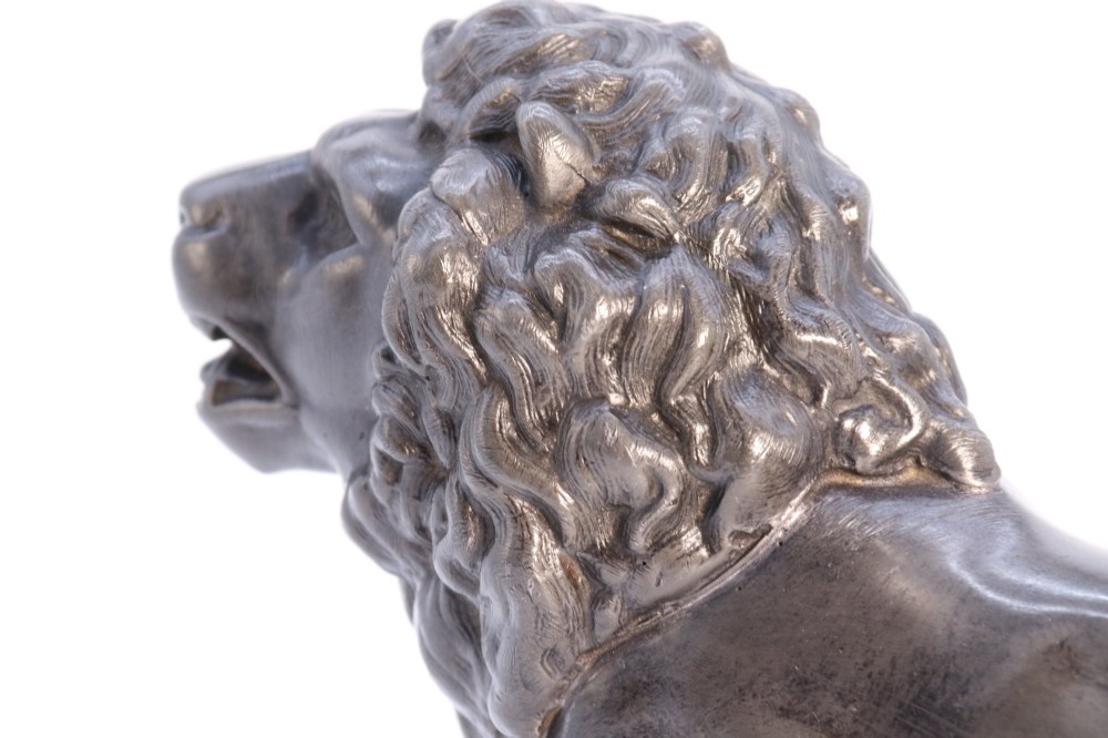 A dark patinated pewter sculpture depicting a standing male lion with a flowing mane and open mouth. View XIII
