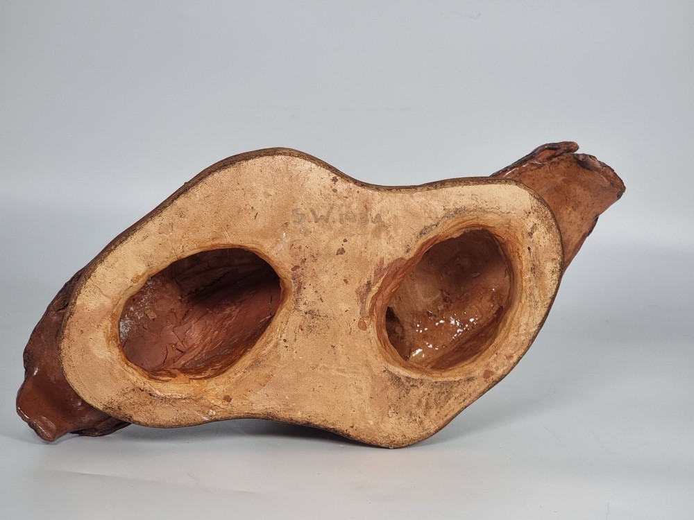 A hand-sculpted warm brown pottery pair of owls featuring textured feather detailing resting on an oval ebonised wooden base. View XII