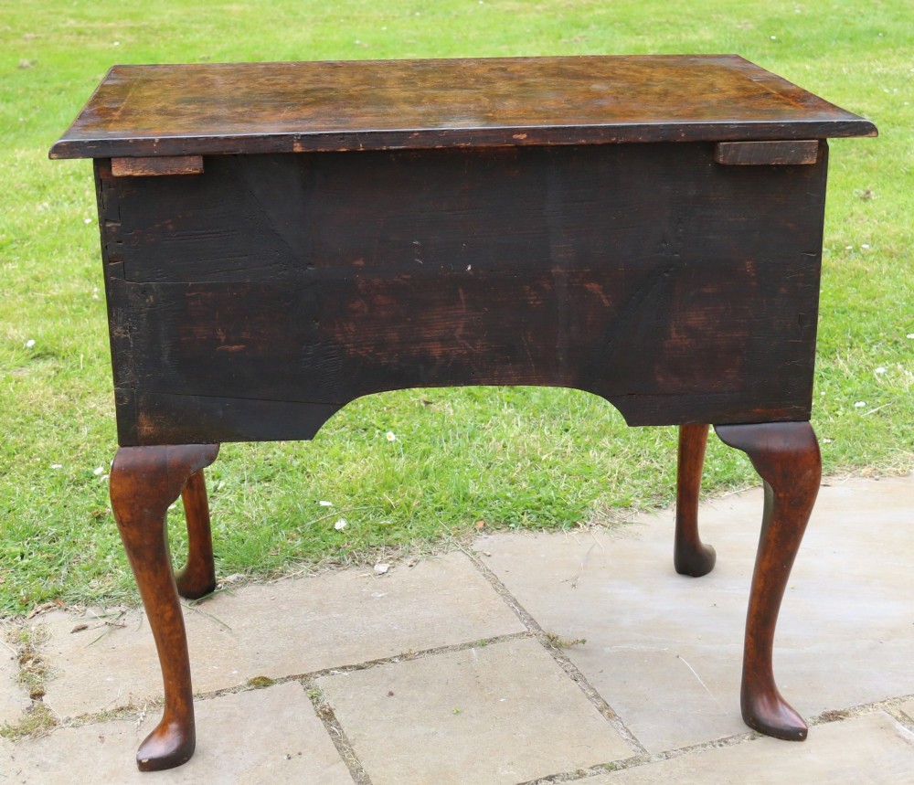 A George II burr elm lowboy table with three drawers, brass handles, a shaped apron, and cabriole legs. View XI