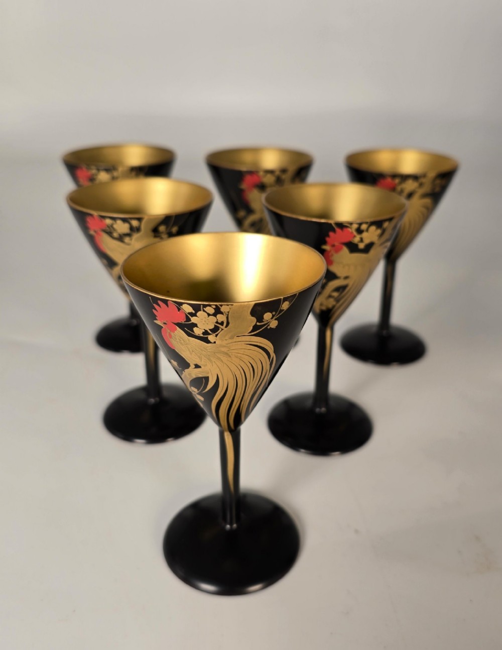 A black and gold hand-painted Japanese lacquer cocktail set comprising a shaker, six stemmed glasses, and a rectangular tray adorned with rooster motifs. View II