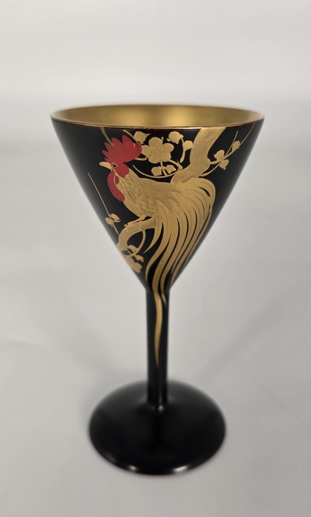 A black and gold hand-painted Japanese lacquer cocktail set comprising a shaker, six stemmed glasses, and a rectangular tray adorned with rooster motifs. View X