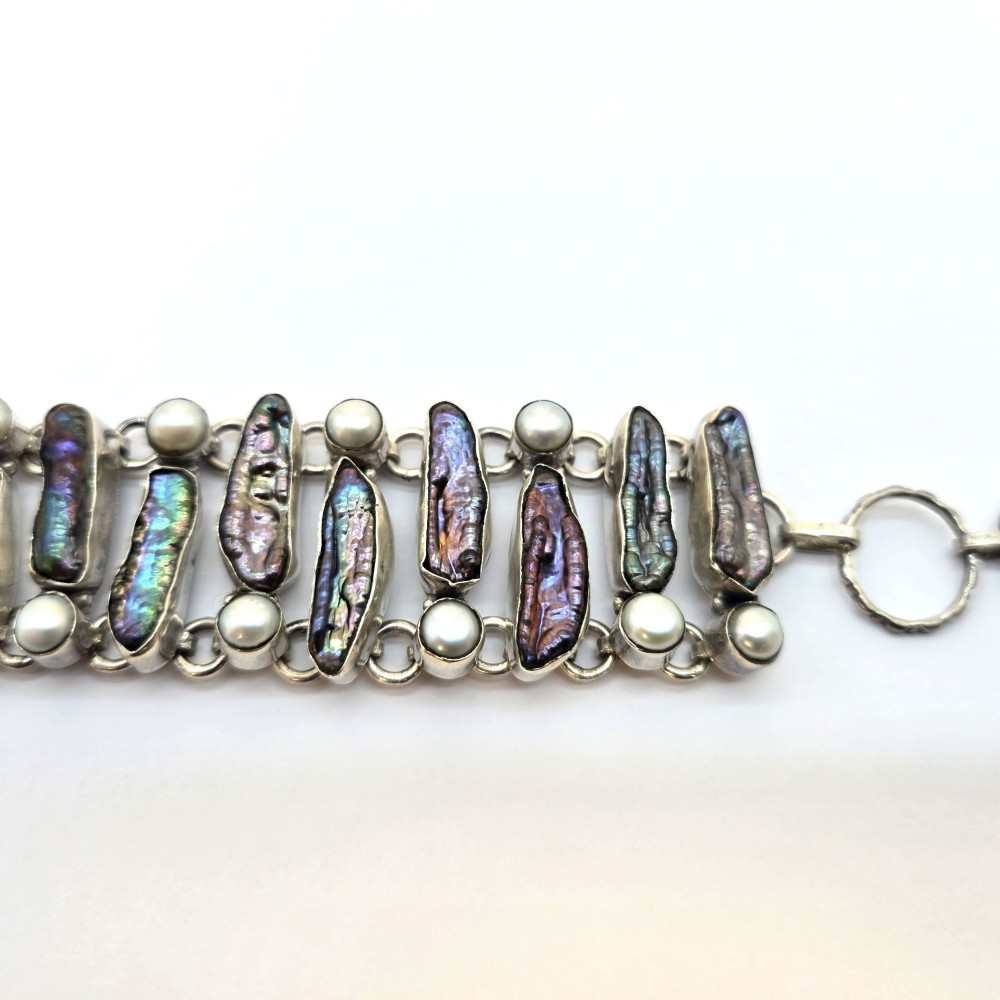 A 1960s Japanese silver jewellery set featuring an articulated link bracelet and a matching ring set with elongated, iridescent Biwa pearls and round white pearls. View II