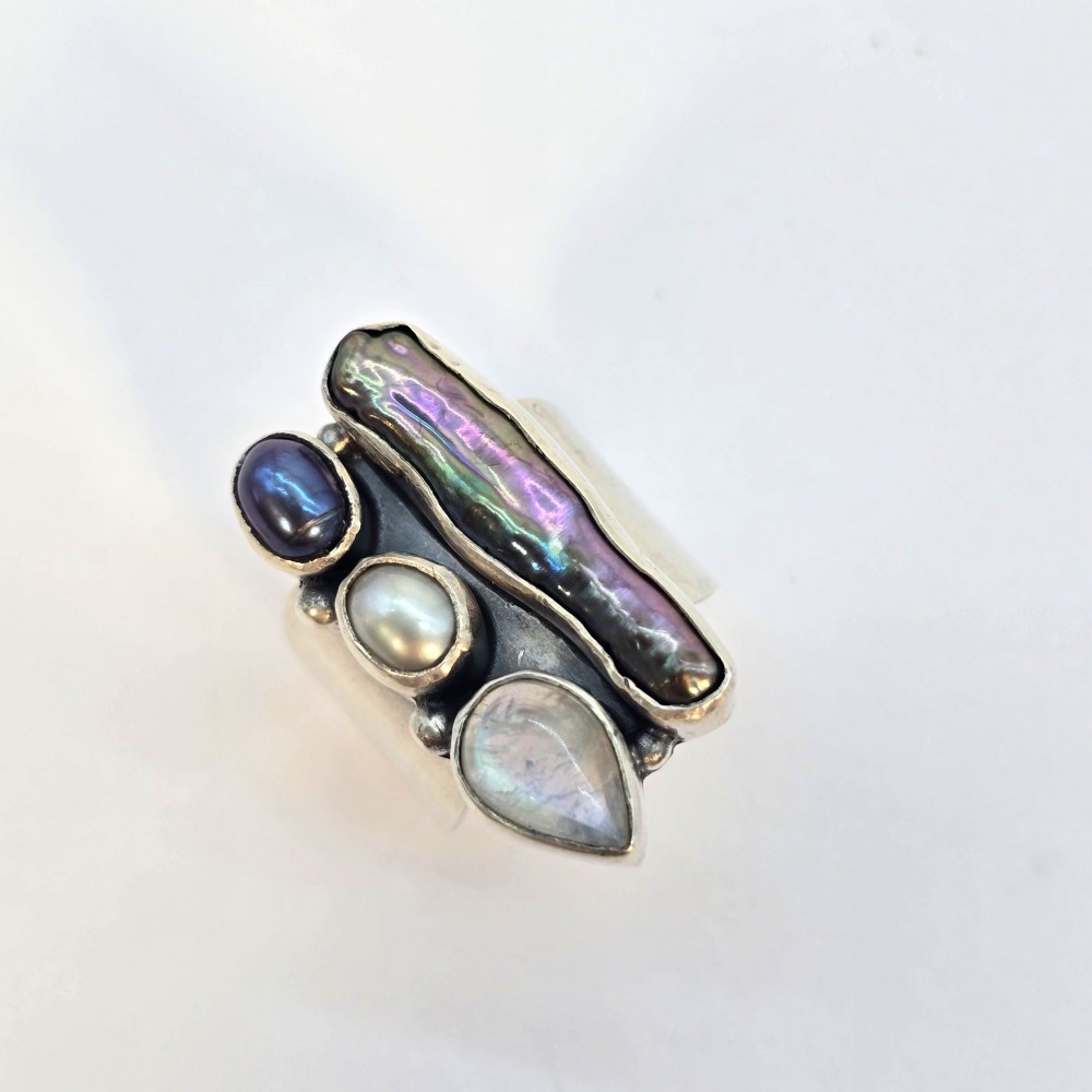 A 1960s Japanese silver jewellery set featuring an articulated link bracelet and a matching ring set with elongated, iridescent Biwa pearls and round white pearls. View X