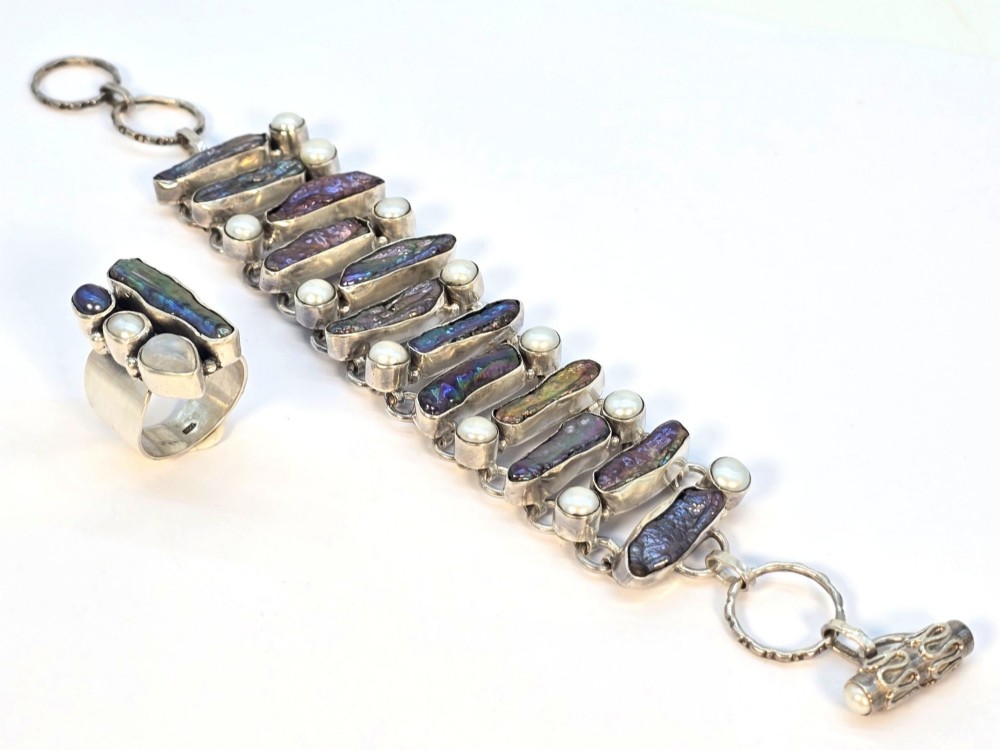 A 1960s Japanese silver jewellery set featuring an articulated link bracelet and a matching ring set with elongated, iridescent Biwa pearls and round white pearls. View XI