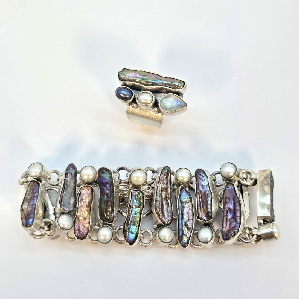 A 1960s Japanese silver jewellery set featuring an articulated link bracelet and a matching ring set with elongated, iridescent Biwa pearls and round white pearls. View XIV