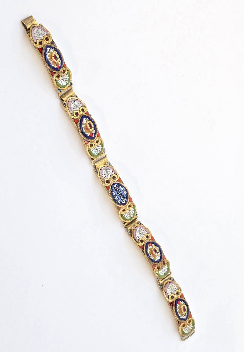 An antique gilt metal link bracelet featuring micro mosaic glass panels, including a central oval panel displaying the word Venezia in white lettering against a blue ground. View IV