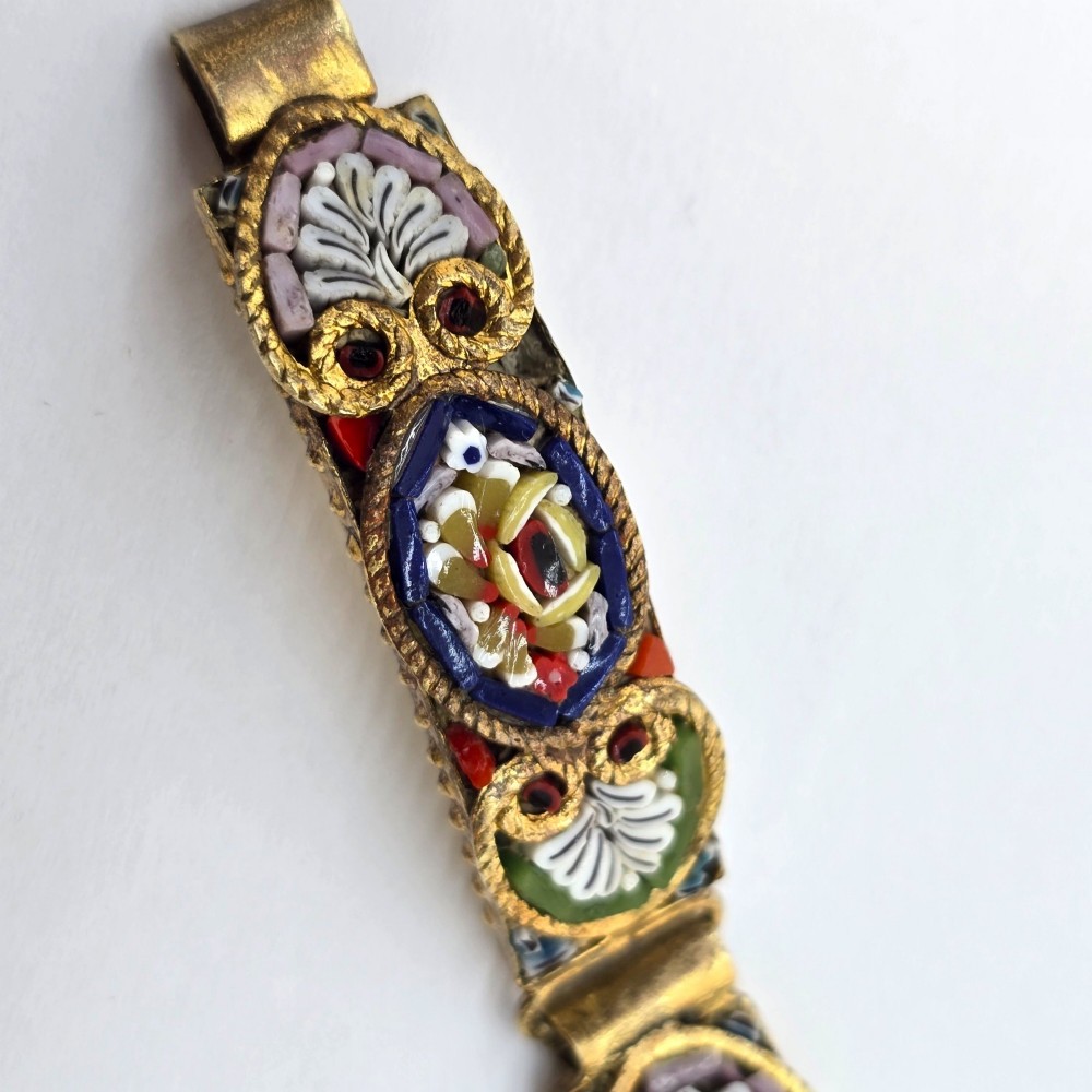 An antique gilt metal link bracelet featuring micro mosaic glass panels, including a central oval panel displaying the word Venezia in white lettering against a blue ground. View VI