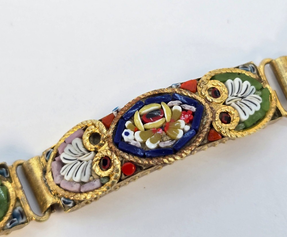 An antique gilt metal link bracelet featuring micro mosaic glass panels, including a central oval panel displaying the word Venezia in white lettering against a blue ground. View VII
