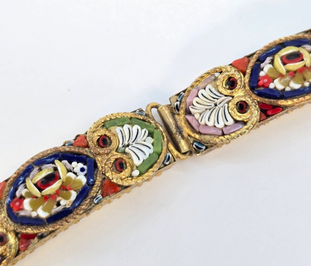 An antique gilt metal link bracelet featuring micro mosaic glass panels, including a central oval panel displaying the word Venezia in white lettering against a blue ground. View VIII