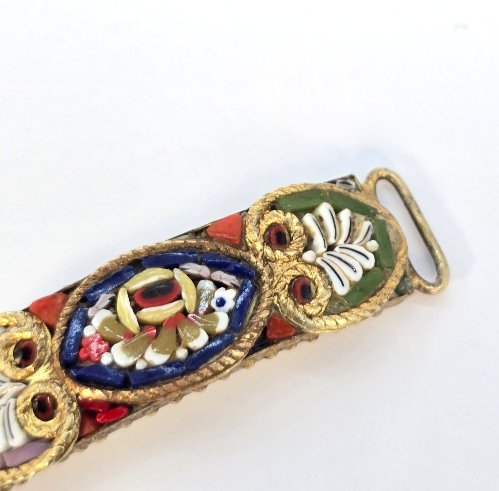 An antique gilt metal link bracelet featuring micro mosaic glass panels, including a central oval panel displaying the word Venezia in white lettering against a blue ground. View IX