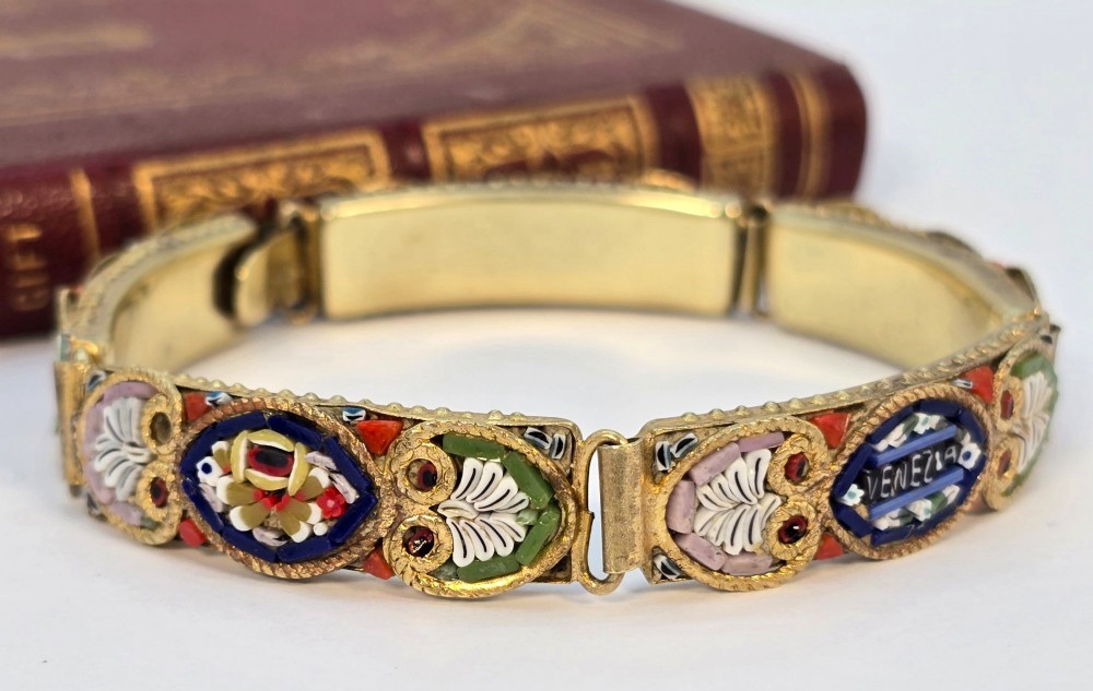 An antique gilt metal link bracelet featuring micro mosaic glass panels, including a central oval panel displaying the word Venezia in white lettering against a blue ground. View XI