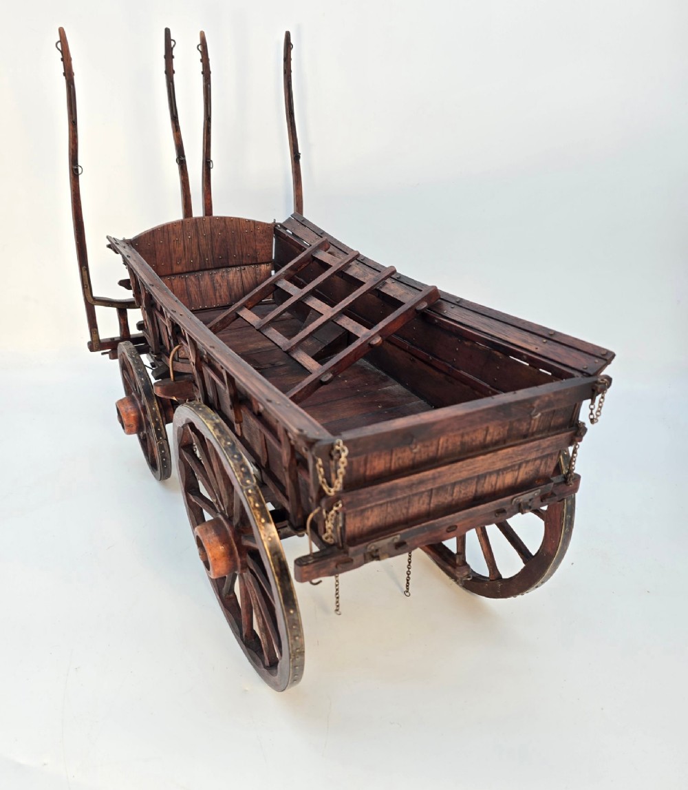 A detailed dark wood scale model of an English twin horse-drawn farm hay cart featuring spoked wheels, iron hardware, and wooden shafts. View IV