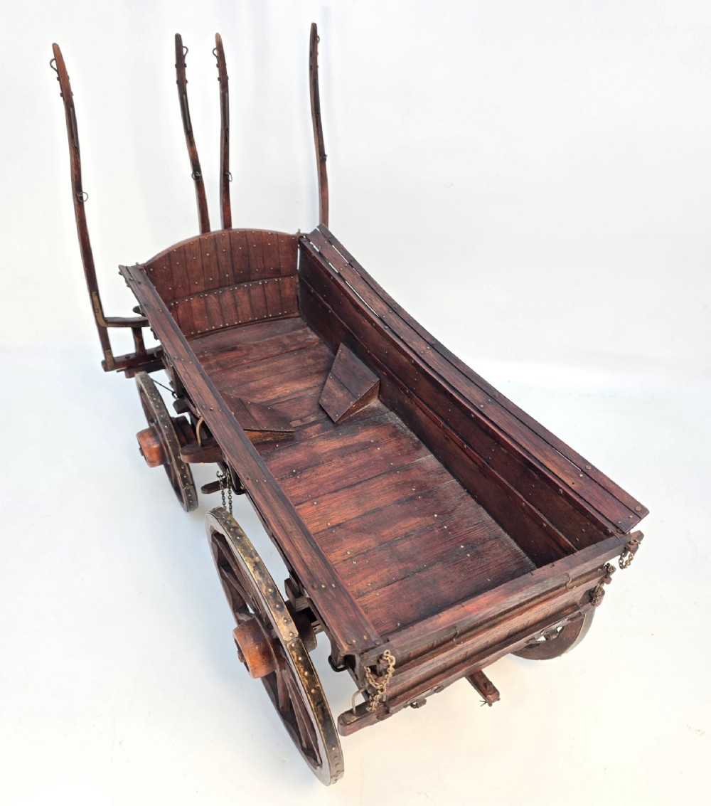 A detailed dark wood scale model of an English twin horse-drawn farm hay cart featuring spoked wheels, iron hardware, and wooden shafts. View V