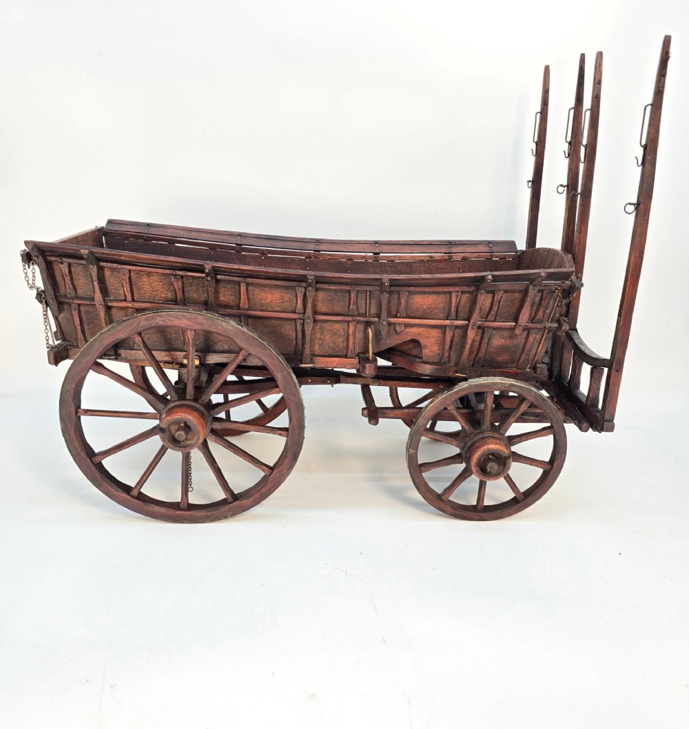 A detailed dark wood scale model of an English twin horse-drawn farm hay cart featuring spoked wheels, iron hardware, and wooden shafts. View VII