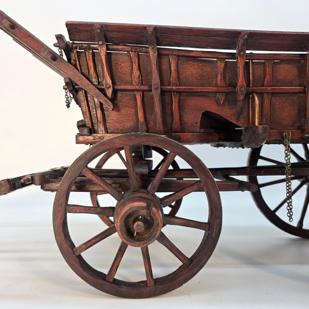 A detailed dark wood scale model of an English twin horse-drawn farm hay cart featuring spoked wheels, iron hardware, and wooden shafts. View XI