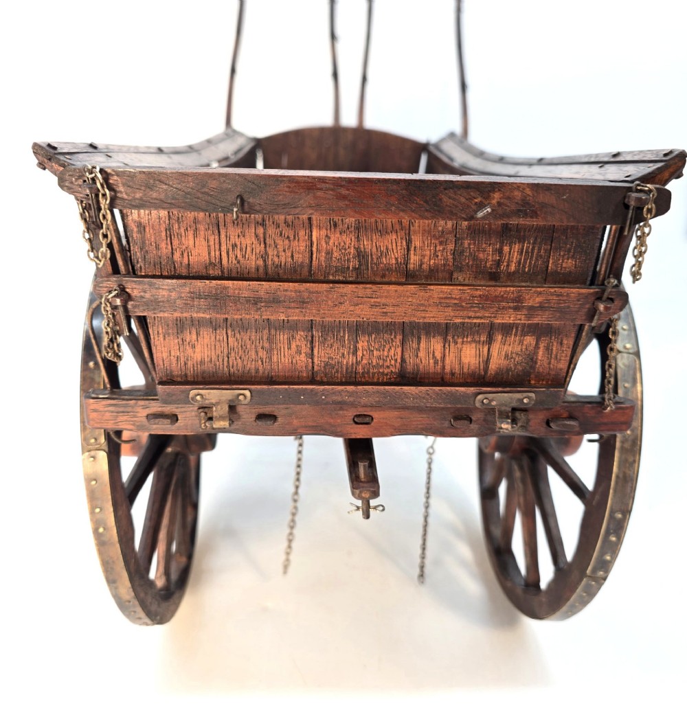 A detailed dark wood scale model of an English twin horse-drawn farm hay cart featuring spoked wheels, iron hardware, and wooden shafts. View XII