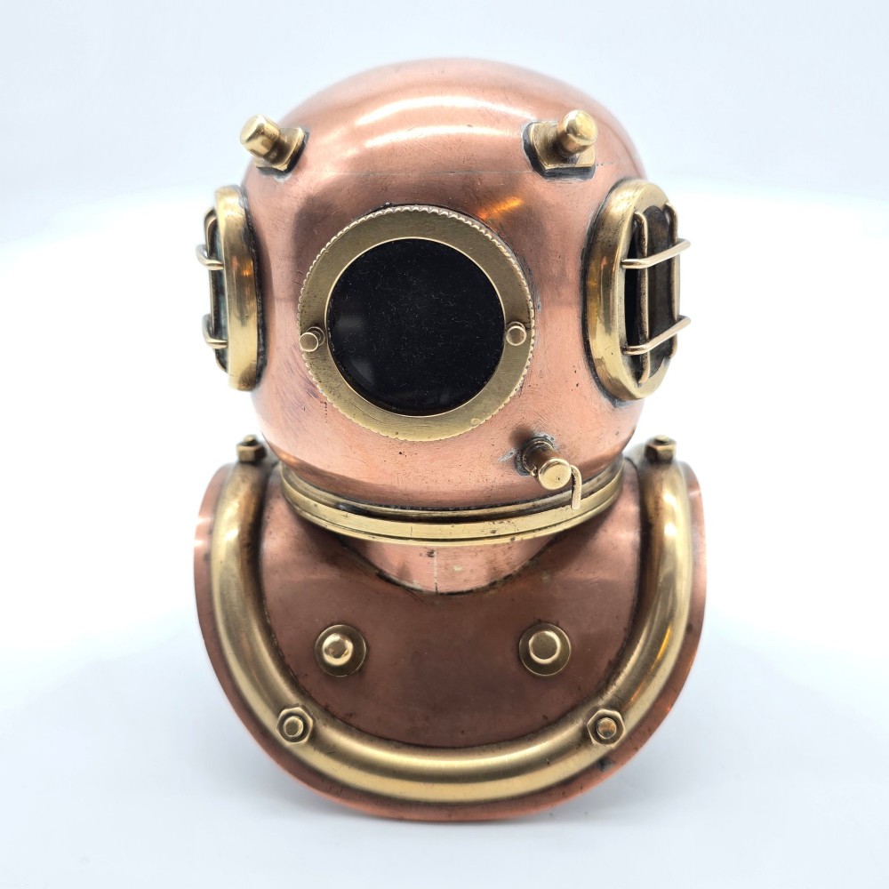 A miniature copper and brass 19th-century style diving helmet with circular glass viewports and a curved corselet base. View V