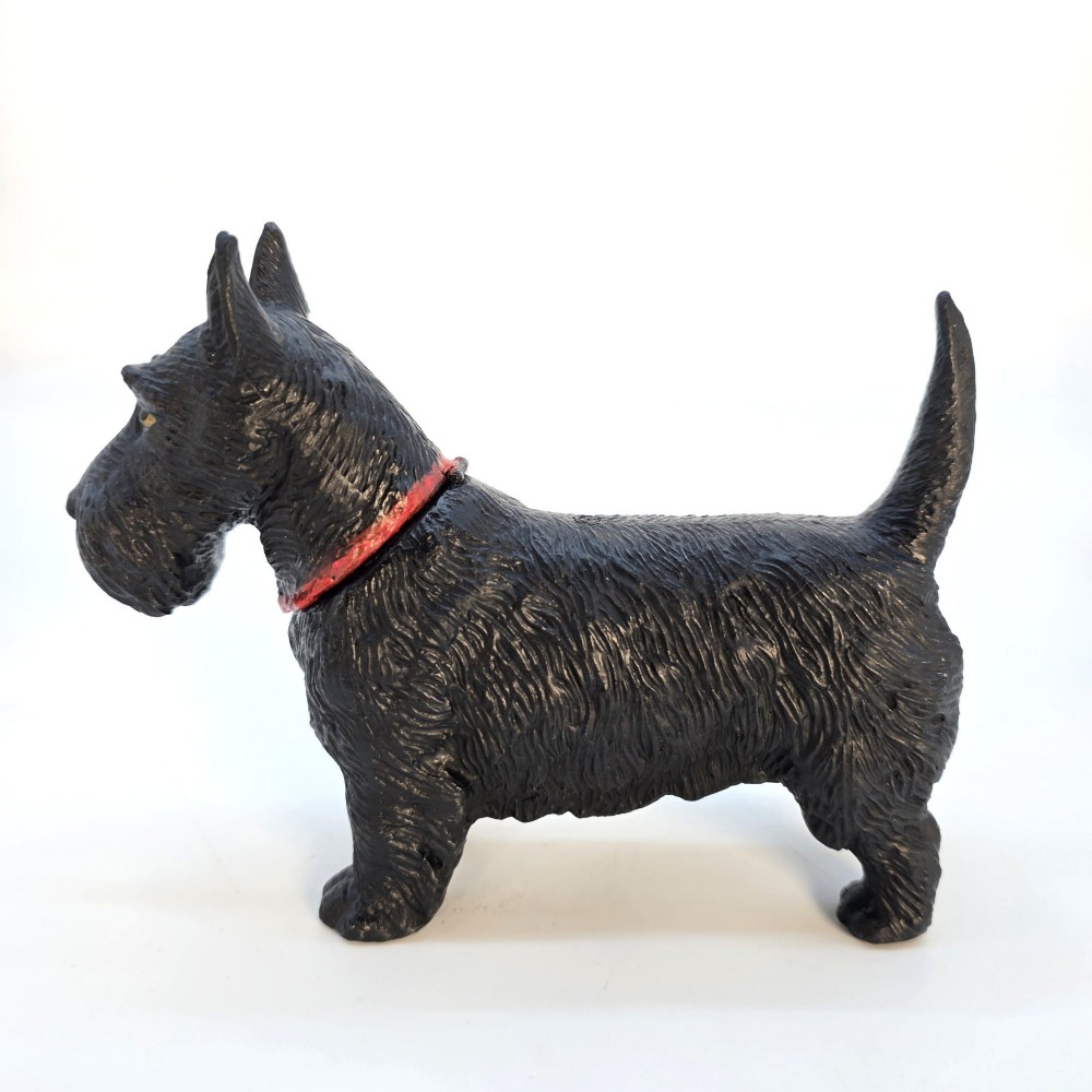 A 1920s black cast metal table lighter crafted in the form of a standing Scottish Terrier with a painted red collar. View IV