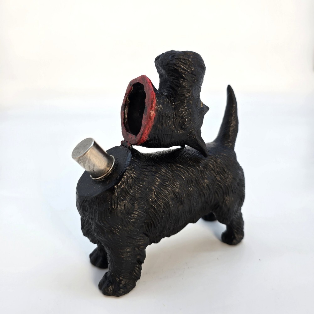 A 1920s black cast metal table lighter crafted in the form of a standing Scottish Terrier with a painted red collar. View VIII