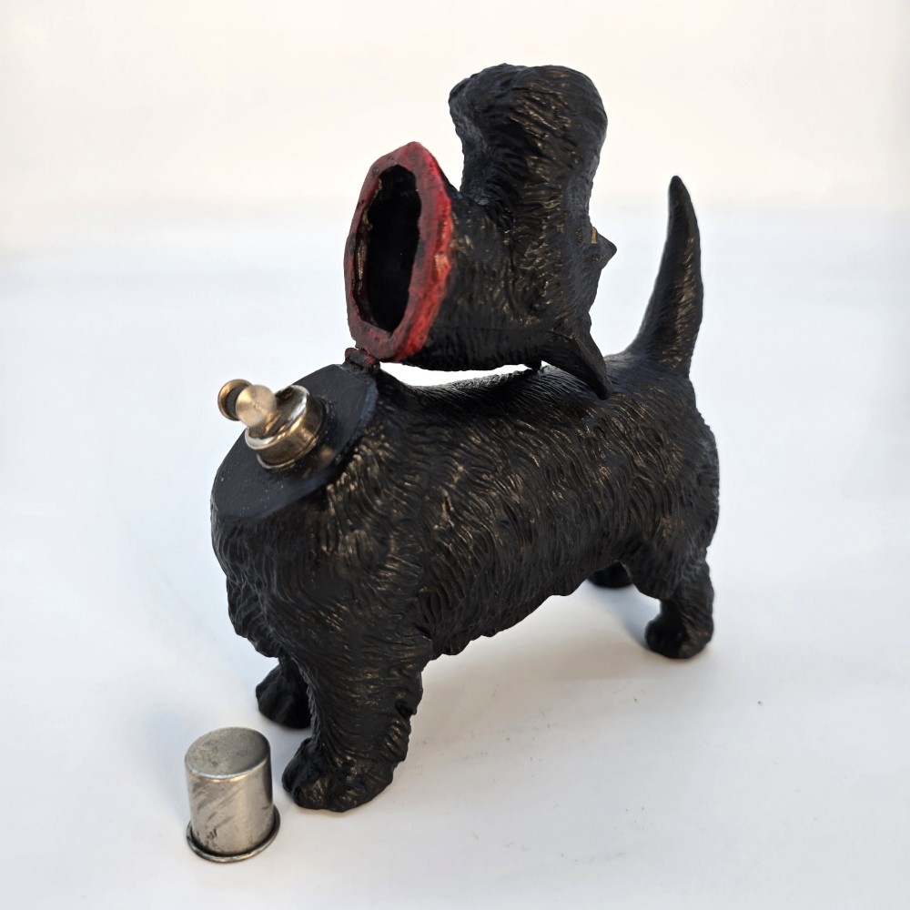 A 1920s black cast metal table lighter crafted in the form of a standing Scottish Terrier with a painted red collar. View IX