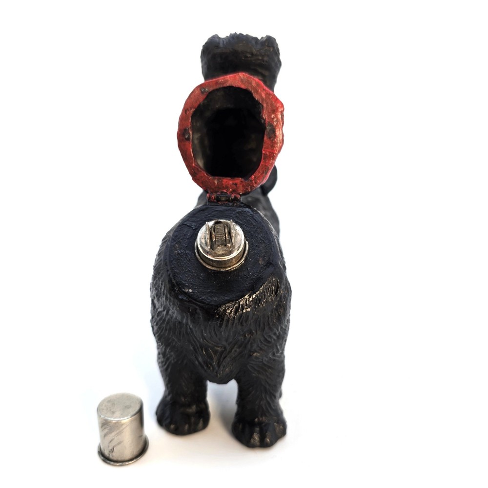 A 1920s black cast metal table lighter crafted in the form of a standing Scottish Terrier with a painted red collar. View X