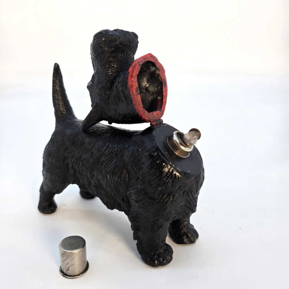 A 1920s black cast metal table lighter crafted in the form of a standing Scottish Terrier with a painted red collar. View XI