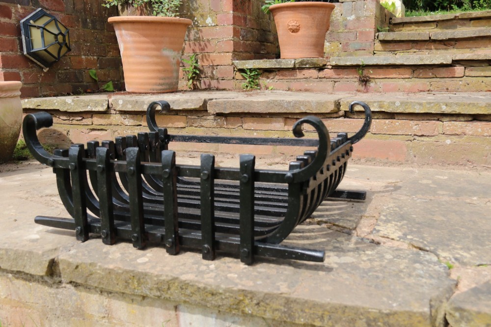 A black wrought iron fire basket featuring vertical slatted bars, hand-riveted joints, and scrolled corner handles. View IV