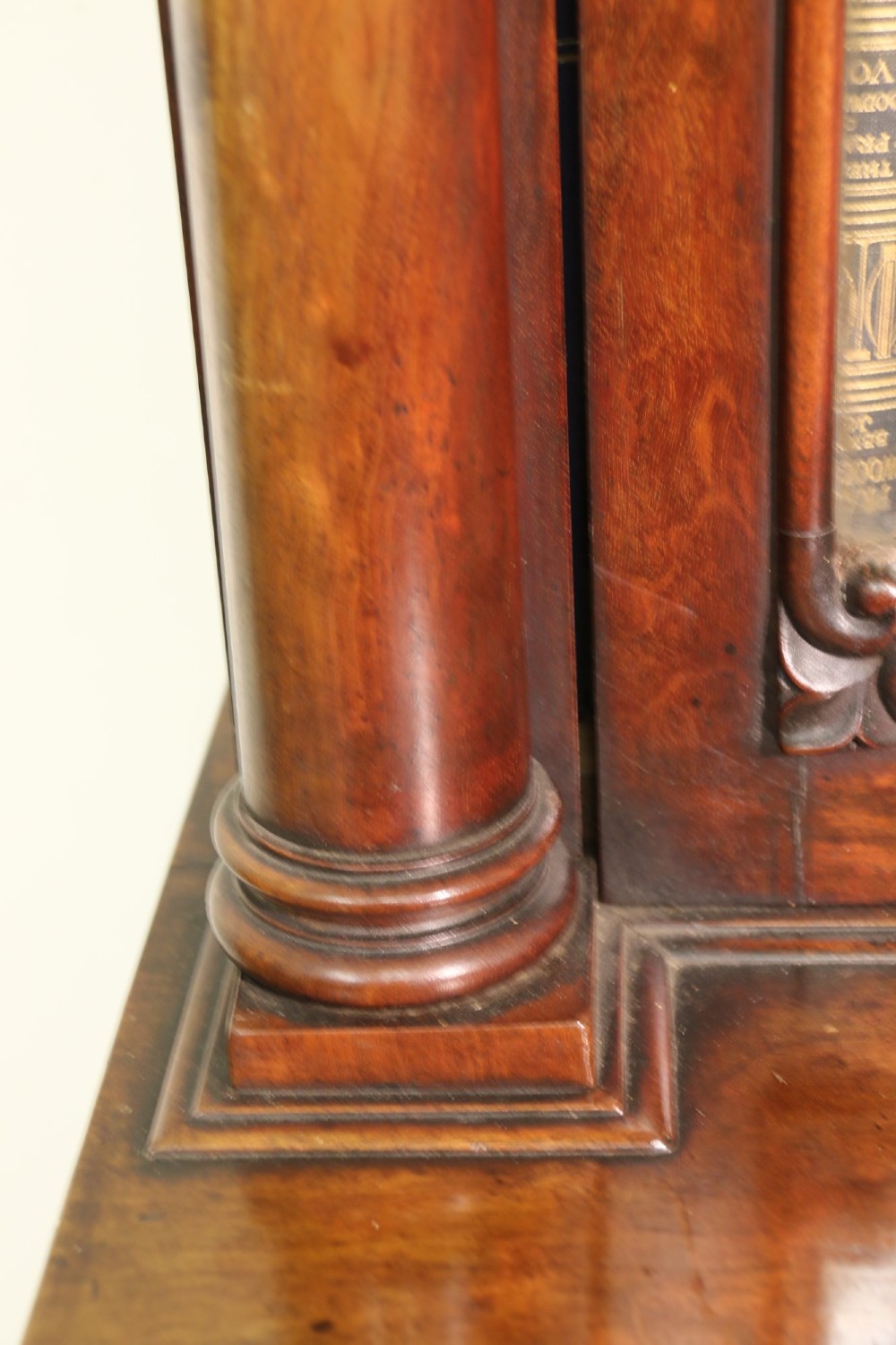 A Regency period mahogany secretaire bookcase with a single glazed upper door, a pull-out writing drawer, and a lower door with fabric and brass grille. View XIII