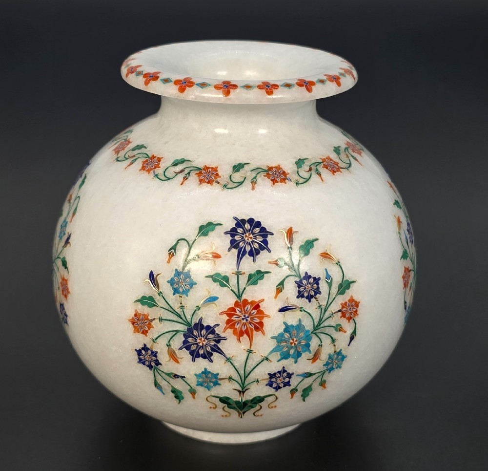 A globular white marble vase adorned with detailed floral pietra dura inlay using multi-coloured semi-precious stones.