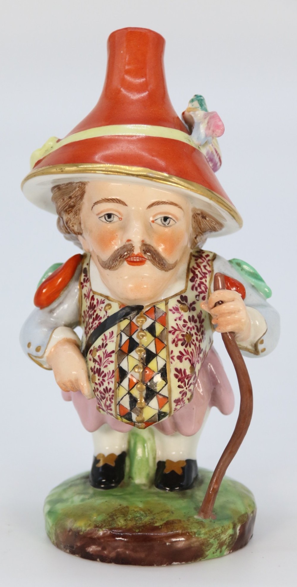 A pair of 19th-century polychrome Samson porcelain figures depicting dwarves wearing oversized brimmed hats and patterned waistcoats on mound bases. View IX