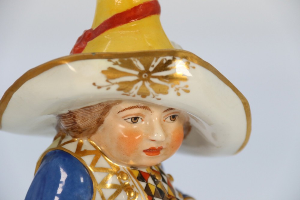 A pair of 19th-century polychrome Samson porcelain figures depicting dwarves wearing oversized brimmed hats and patterned waistcoats on mound bases. View XV