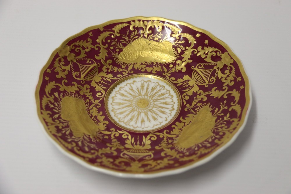 An early nineteenth-century Regency Spode porcelain cabinet cup and saucer featuring deep crimson ground decorated with heavy gilded scrollwork and shell motifs. View IV