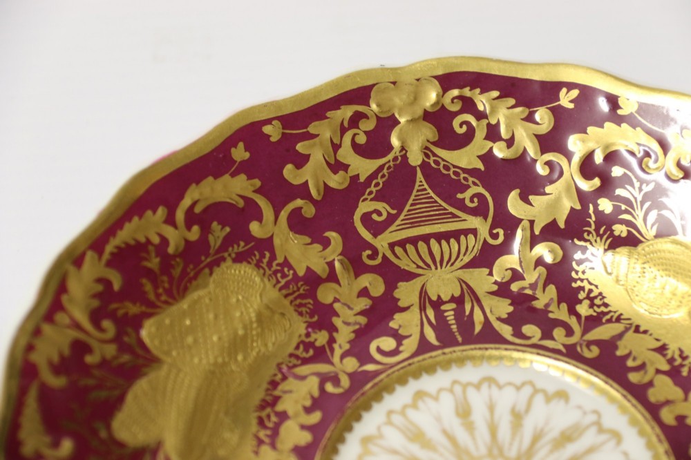 An early nineteenth-century Regency Spode porcelain cabinet cup and saucer featuring deep crimson ground decorated with heavy gilded scrollwork and shell motifs. View VIII