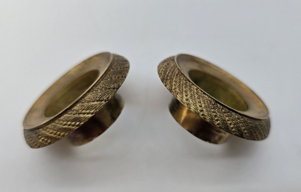 A pair of nineteenth-century French Empire gilt-bronze candlesticks featuring urn-shaped nozzles and applied bronze foliage on rectangular yellow marble bases. View XV