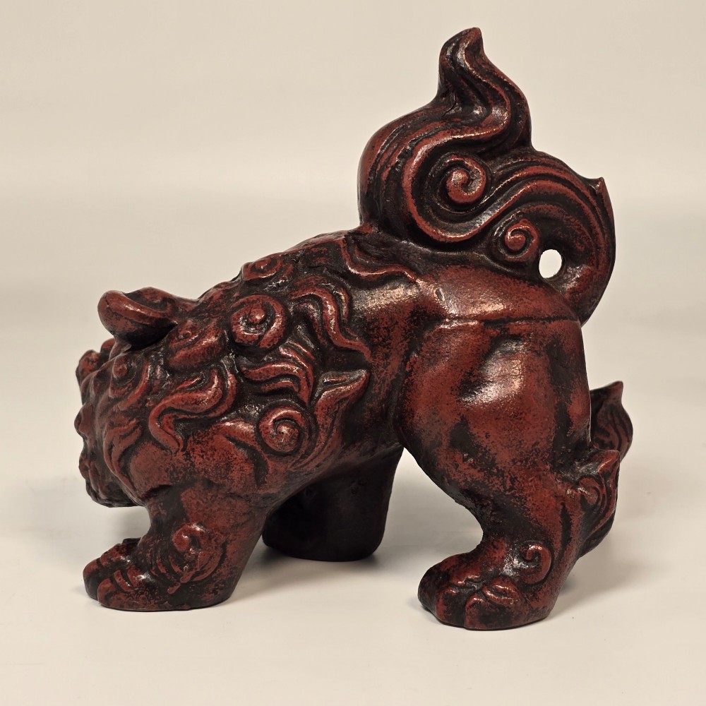 A pair of reddish-brown cast iron Chinoiserie guardian lions with swirling manes and open mouths displaying white painted teeth. View VI