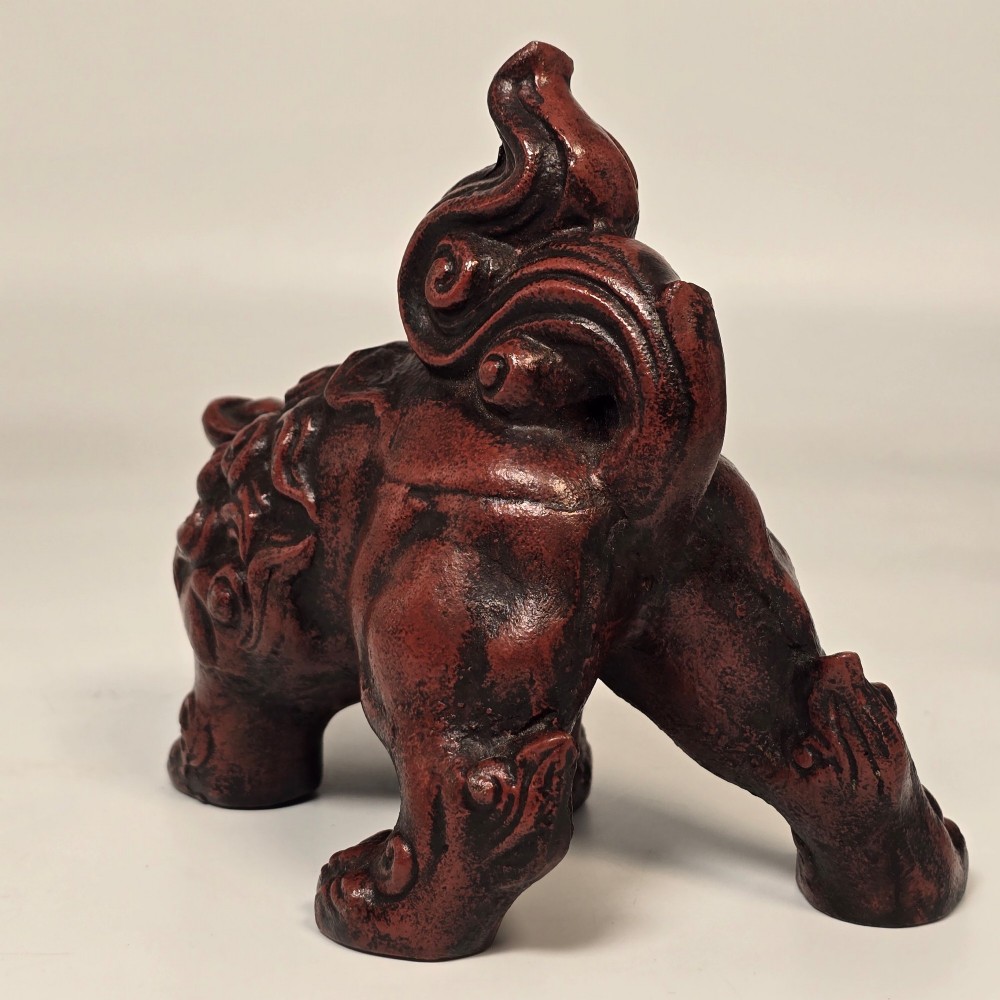 A pair of reddish-brown cast iron Chinoiserie guardian lions with swirling manes and open mouths displaying white painted teeth. View VII