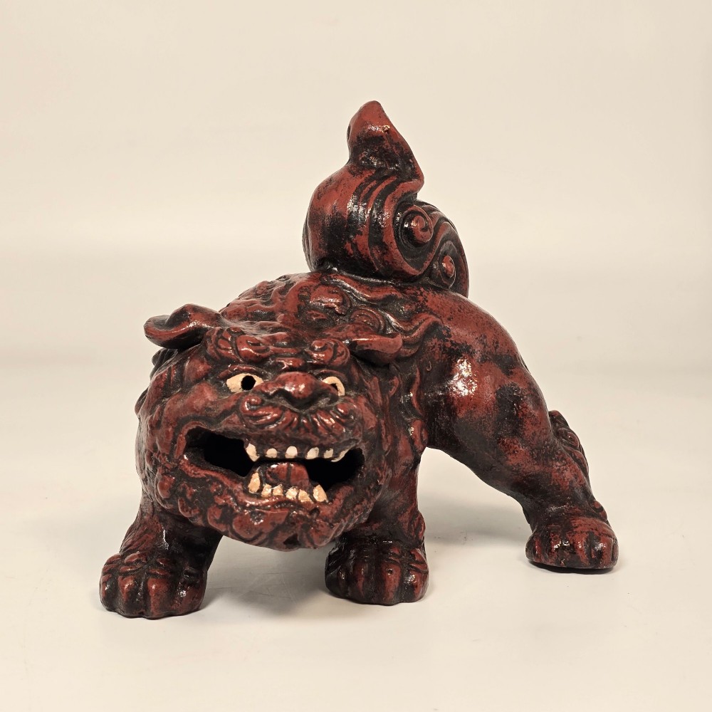 A pair of reddish-brown cast iron Chinoiserie guardian lions with swirling manes and open mouths displaying white painted teeth. View XI