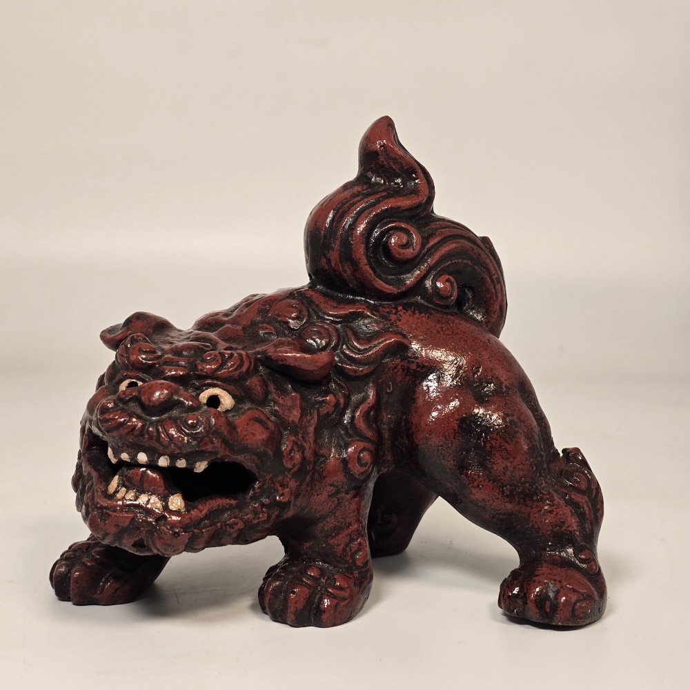 A pair of reddish-brown cast iron Chinoiserie guardian lions with swirling manes and open mouths displaying white painted teeth. View XII