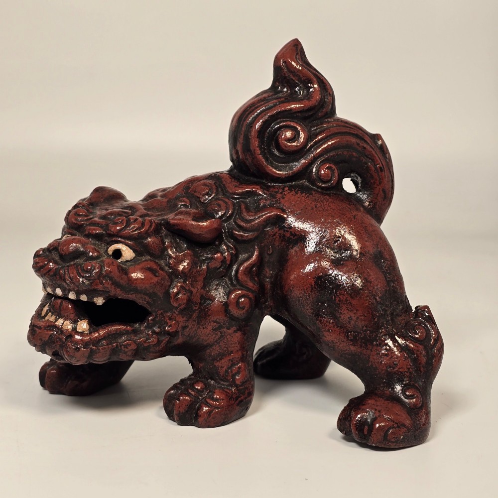 A pair of reddish-brown cast iron Chinoiserie guardian lions with swirling manes and open mouths displaying white painted teeth. View XIII