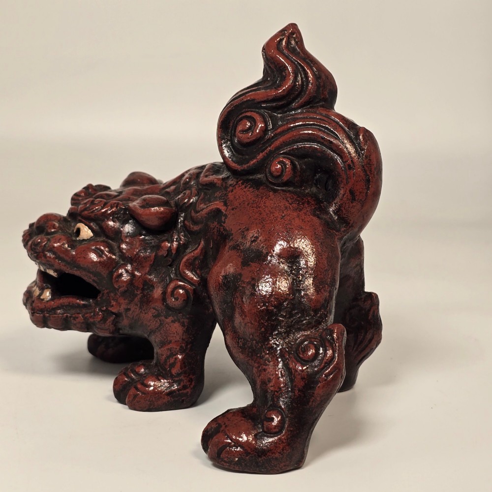 A pair of reddish-brown cast iron Chinoiserie guardian lions with swirling manes and open mouths displaying white painted teeth. View XIV