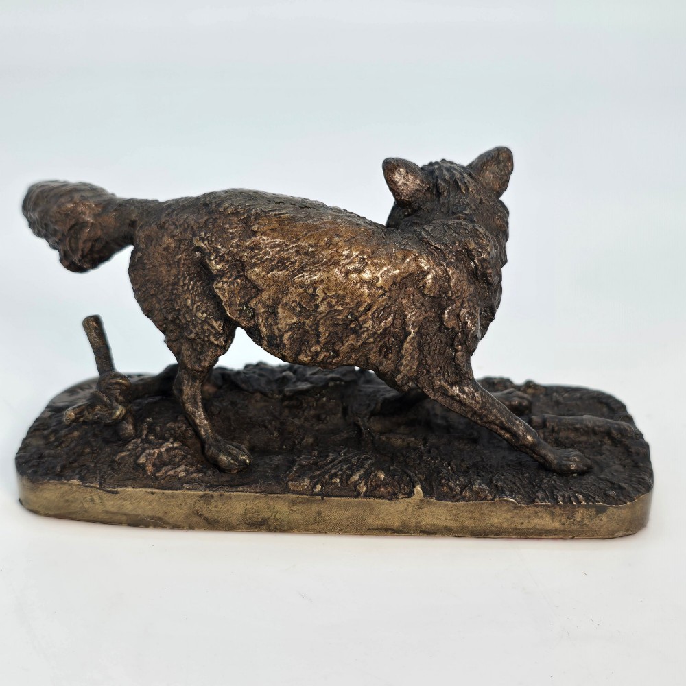 A dark brown patinated bronze sculpture depicting a crouching fox on a naturalistic textured base. View IV