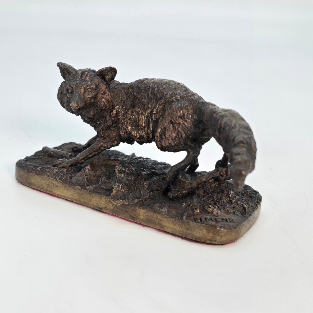 A dark brown patinated bronze sculpture depicting a crouching fox on a naturalistic textured base. View VI